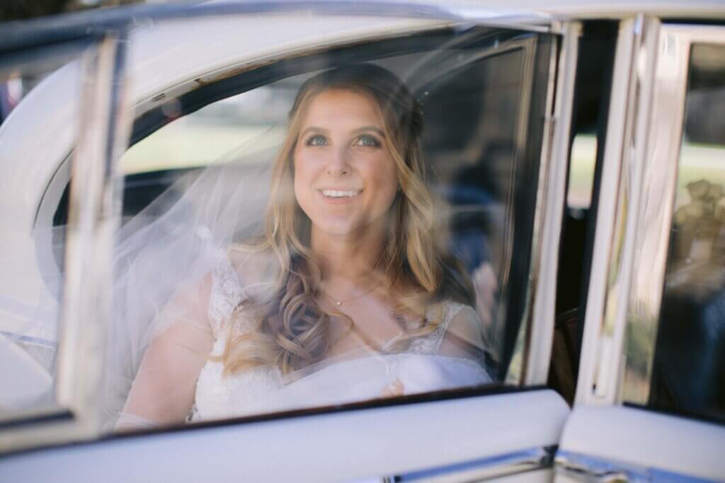 Bride in a classic Jaguar at Duke Chapel 